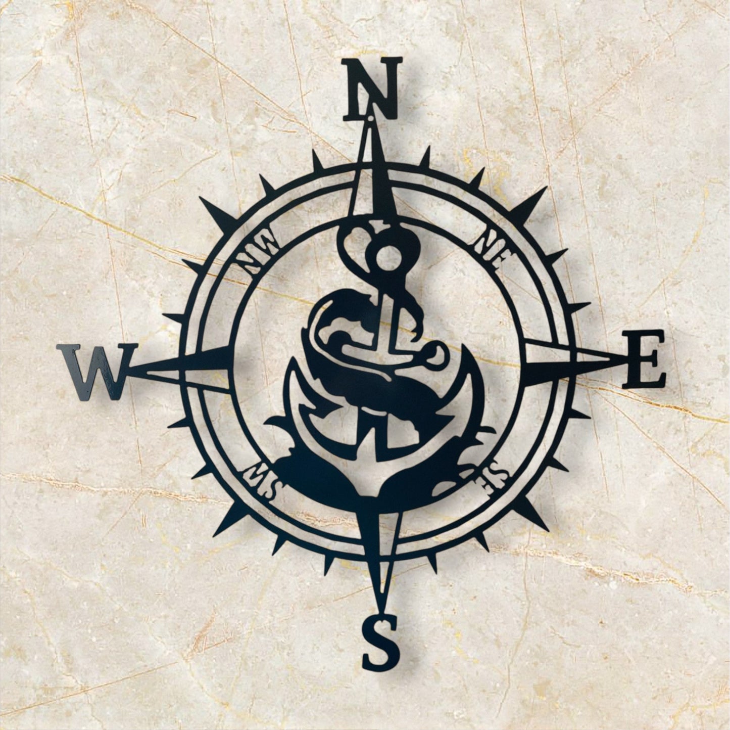 Navy blue compass with anchor design on a beige marble background