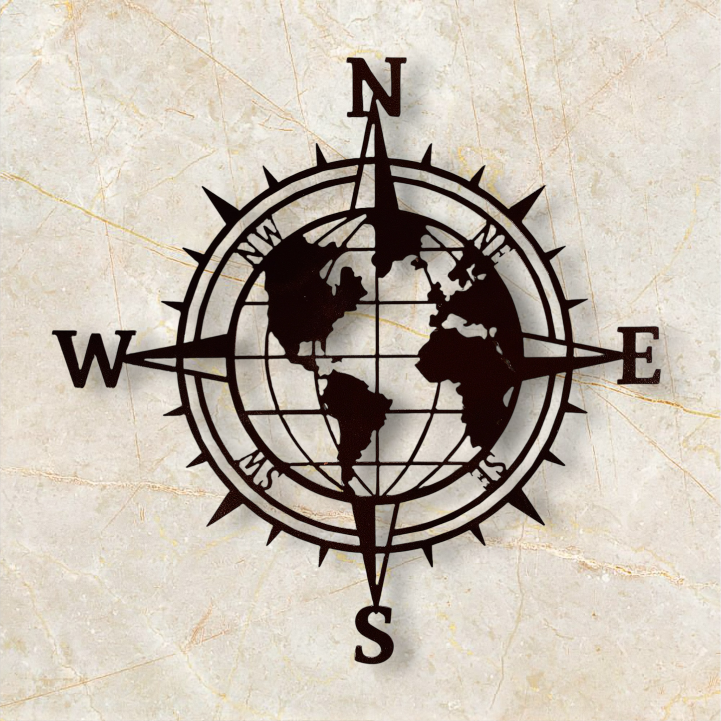 Black compass with world map design on a beige marble background