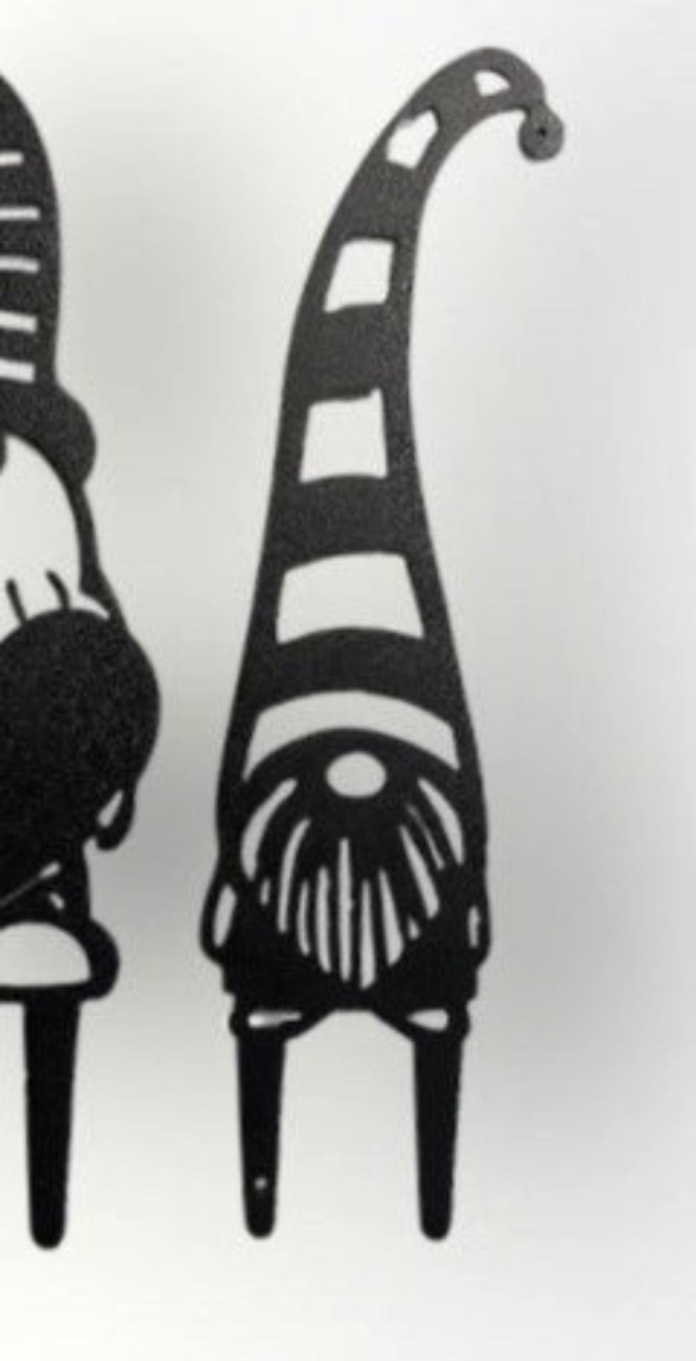Little metal garden gnome with stripped hat and beard