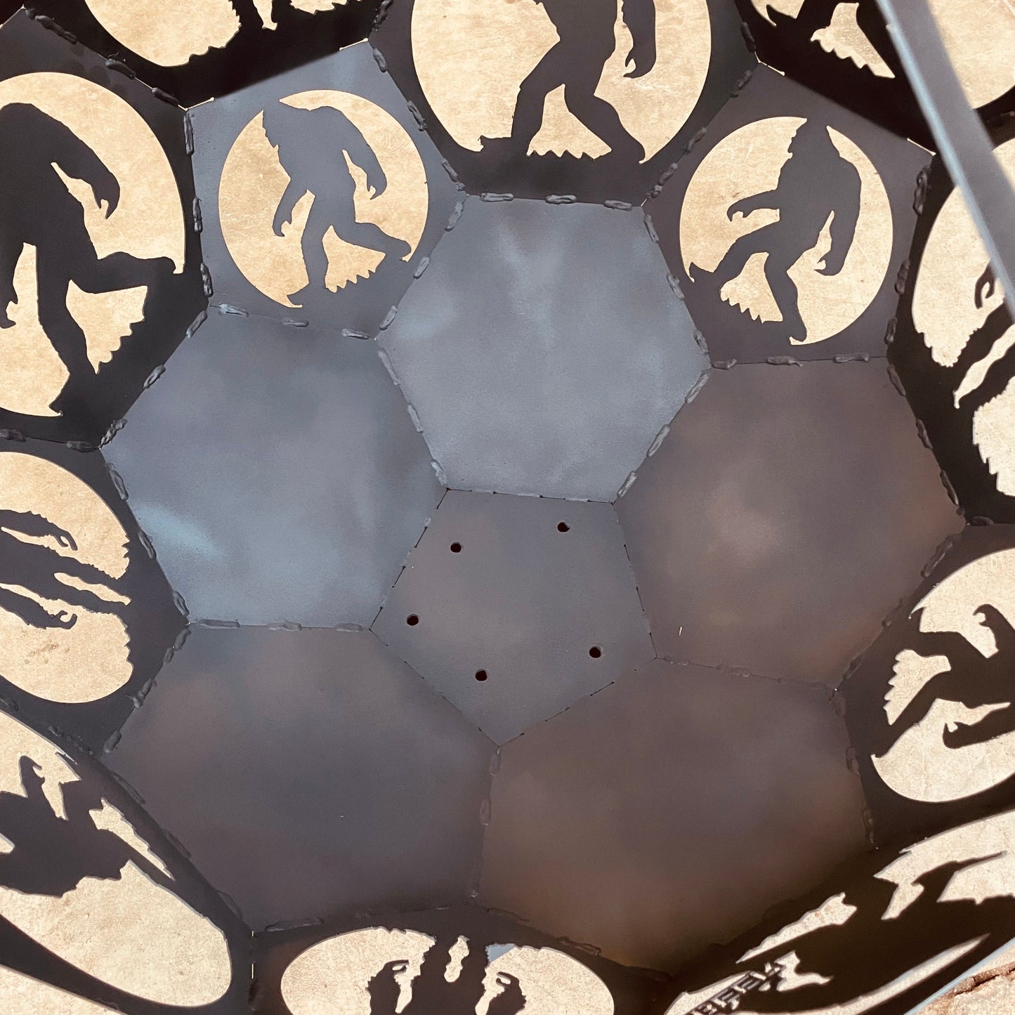 Inside view of round fire pit with a Bigfoot theme.