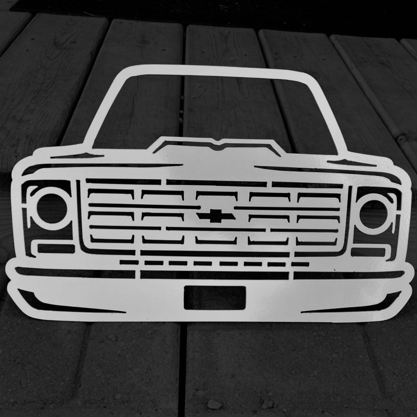 Metallic car front design on a wooden surface