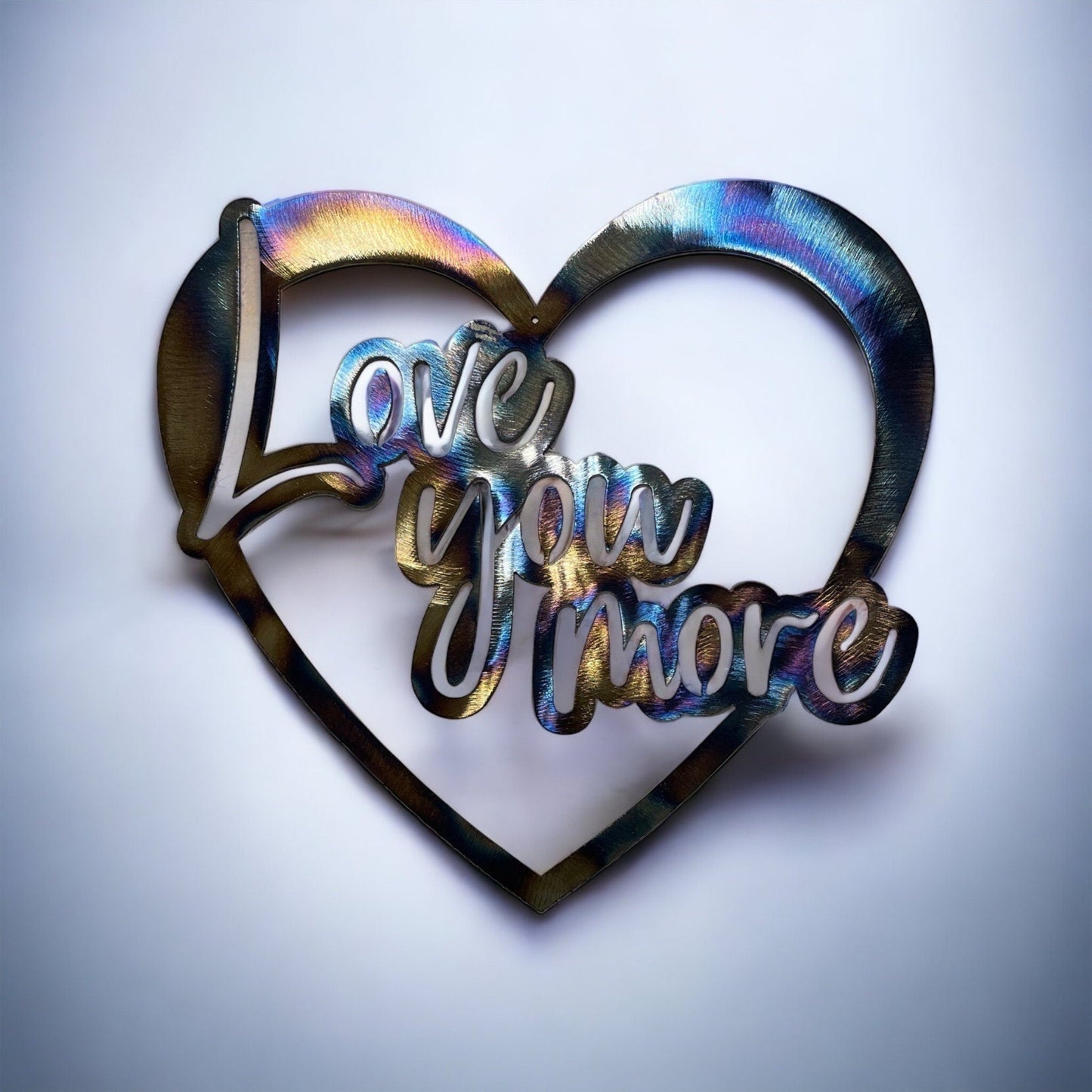 multicolored metal heart that says "Love you more"