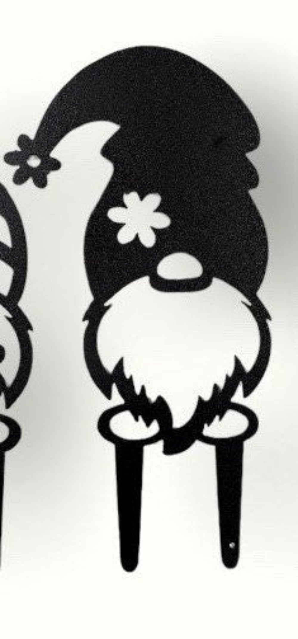Little metal garden gnome with flower on hat