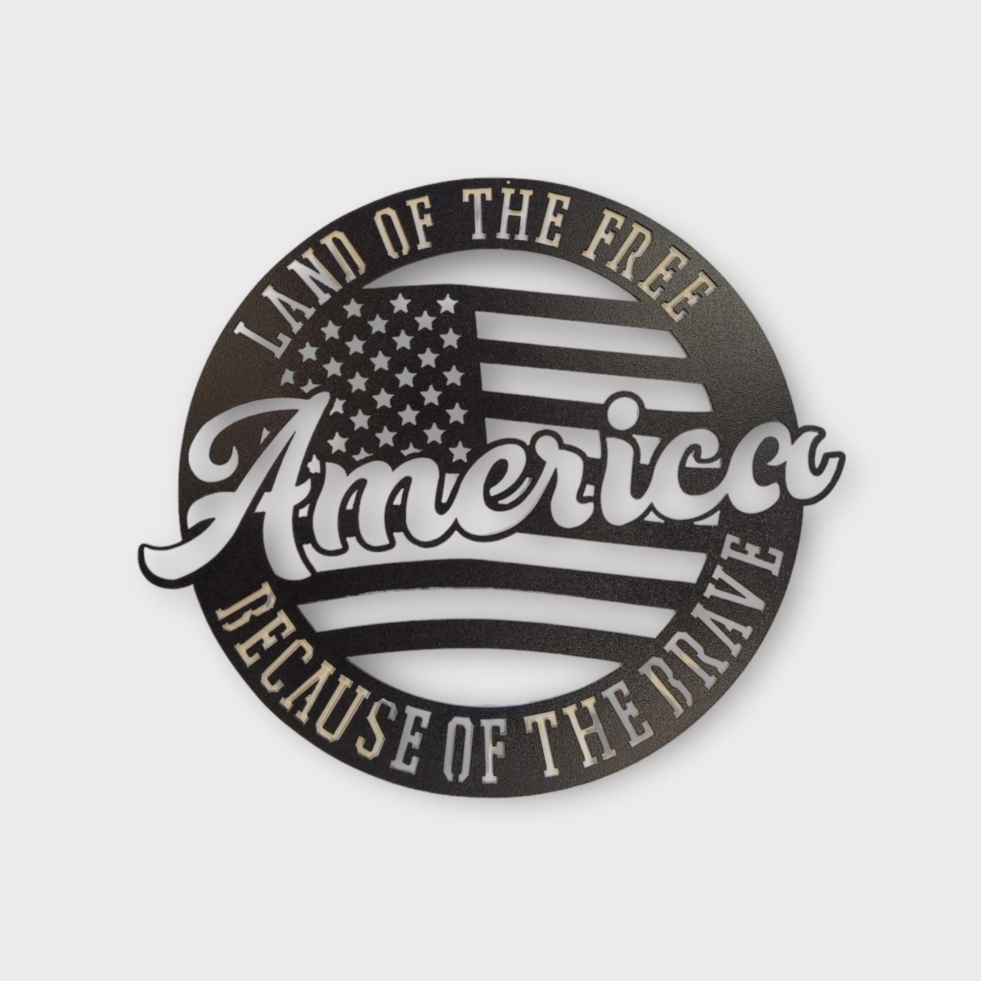 Metal wall art that reads "America, Land of the free because of the brave"