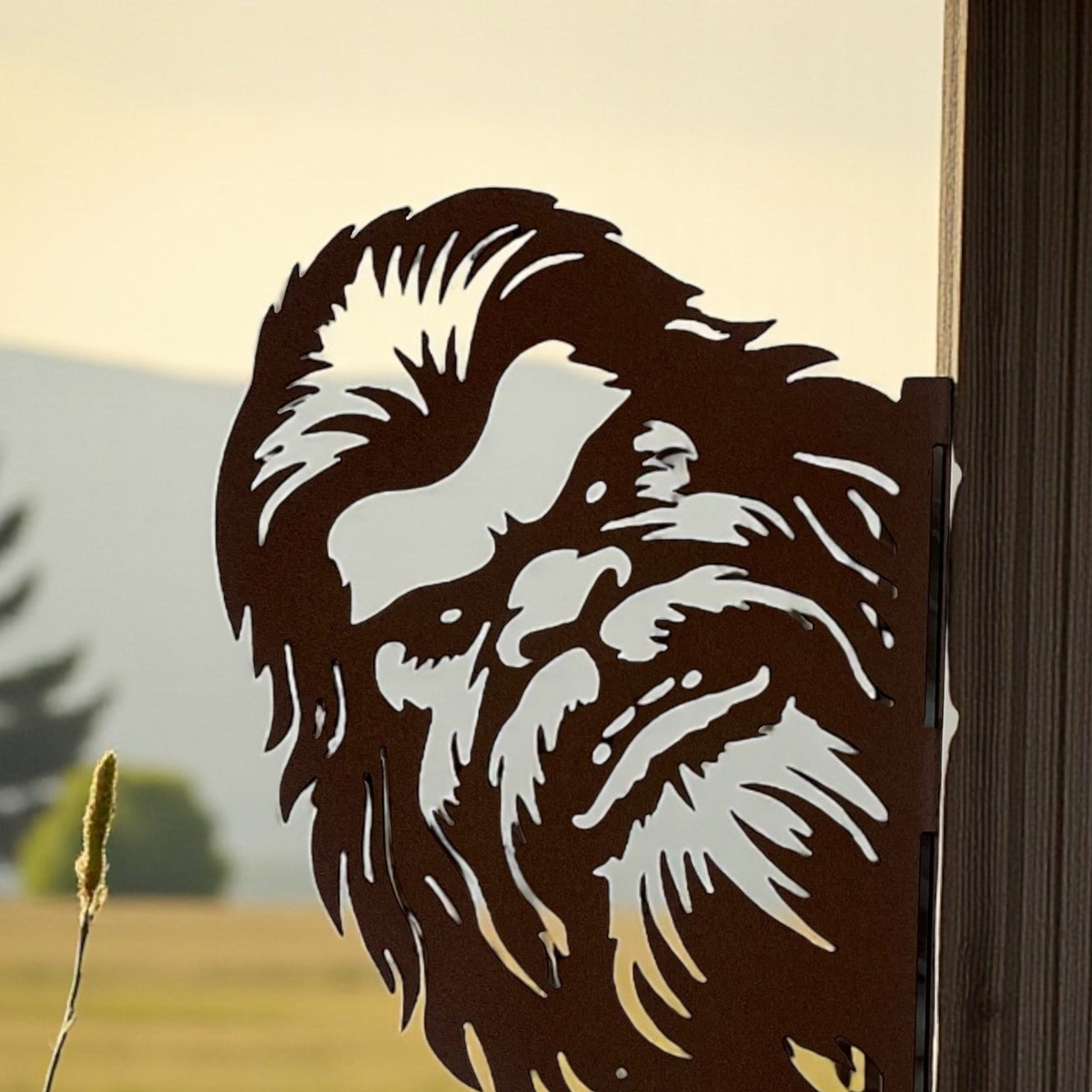 Metal Sasquatch cutout on fence post with a middle finger.