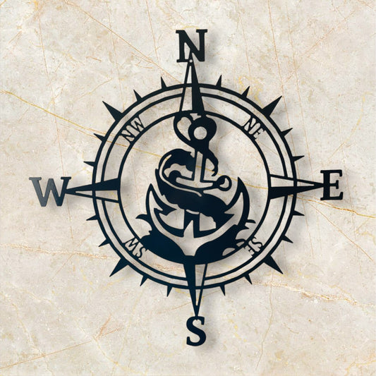 Navy blue compass with anchor design on a beige marble background