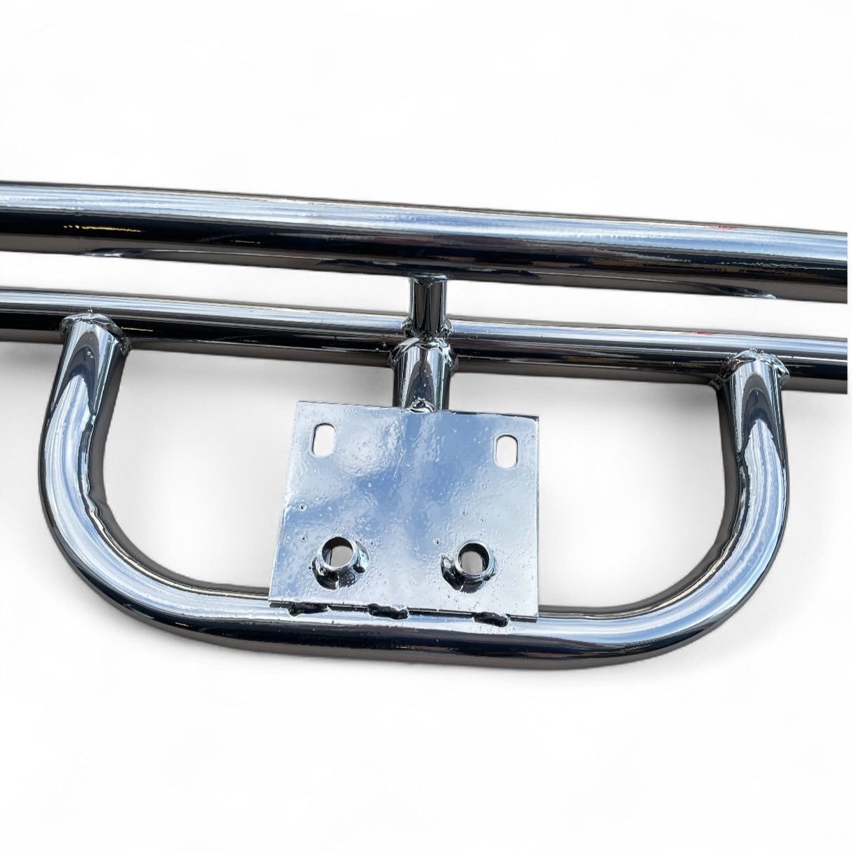 Close-up of a chrome bumper on a white background