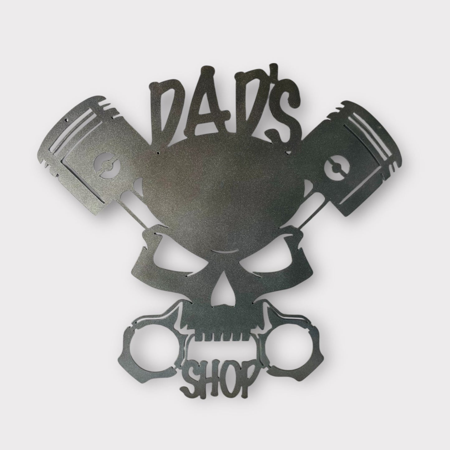 Metal wall art with 'Dad's Shop' text and piston design on a white background