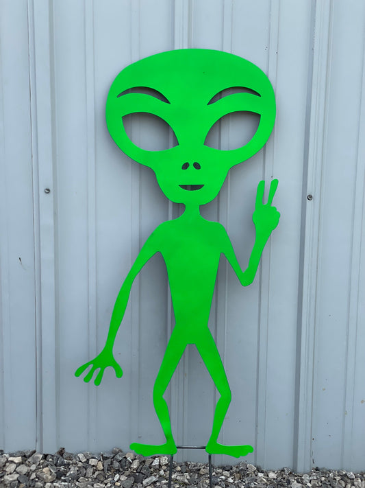 Alien green Martian holding up a peace sign.