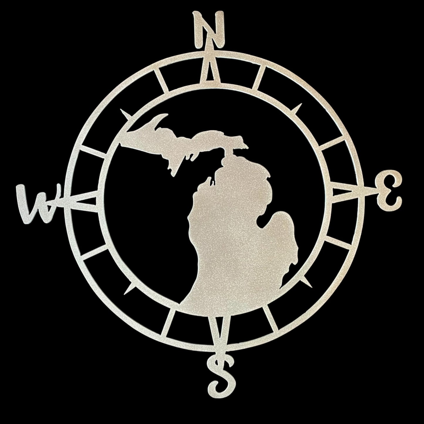 Decorative metal sign with a compass design and silhouette of a state on a black background