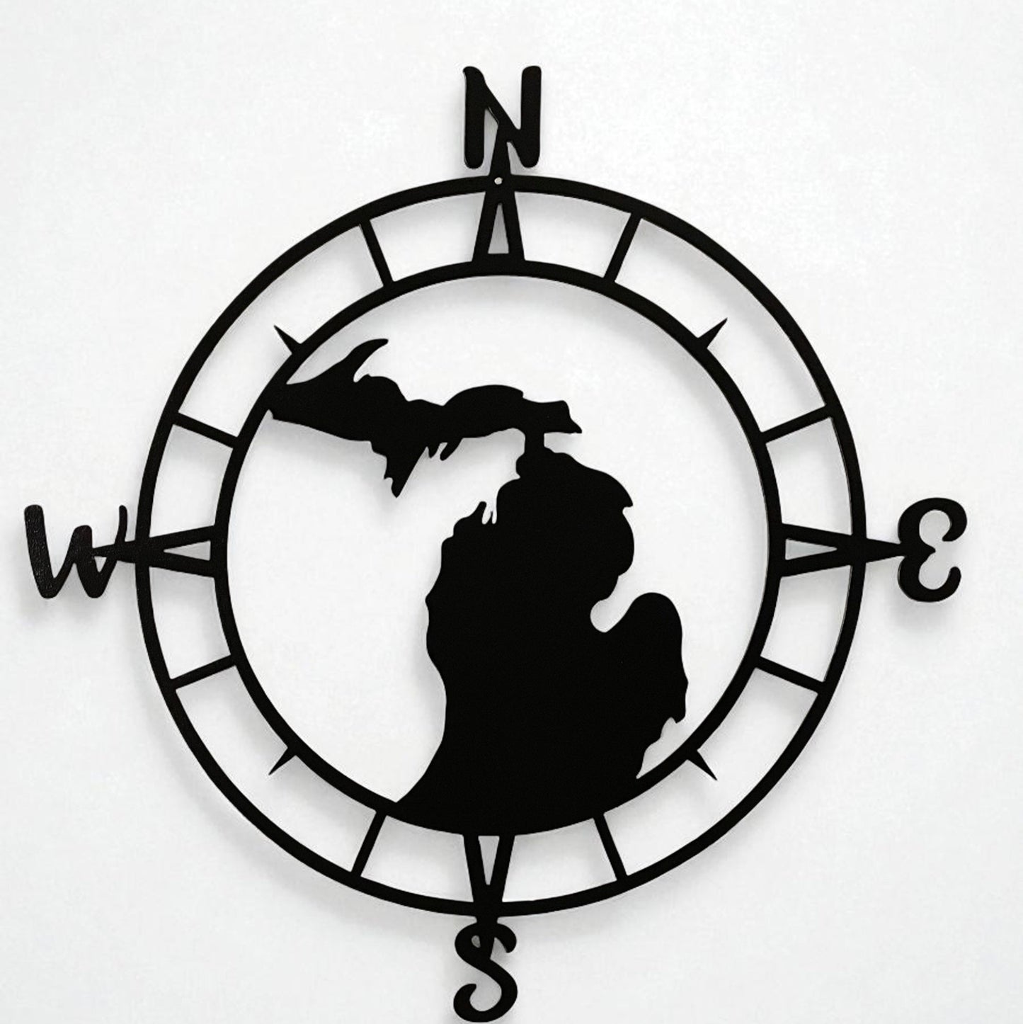Black silhouette of Michigan in a compass rose design on a white background