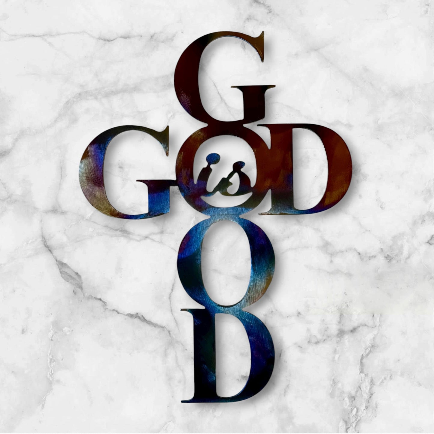 Colorful 'GOD is Good" metal wall art on a marble background