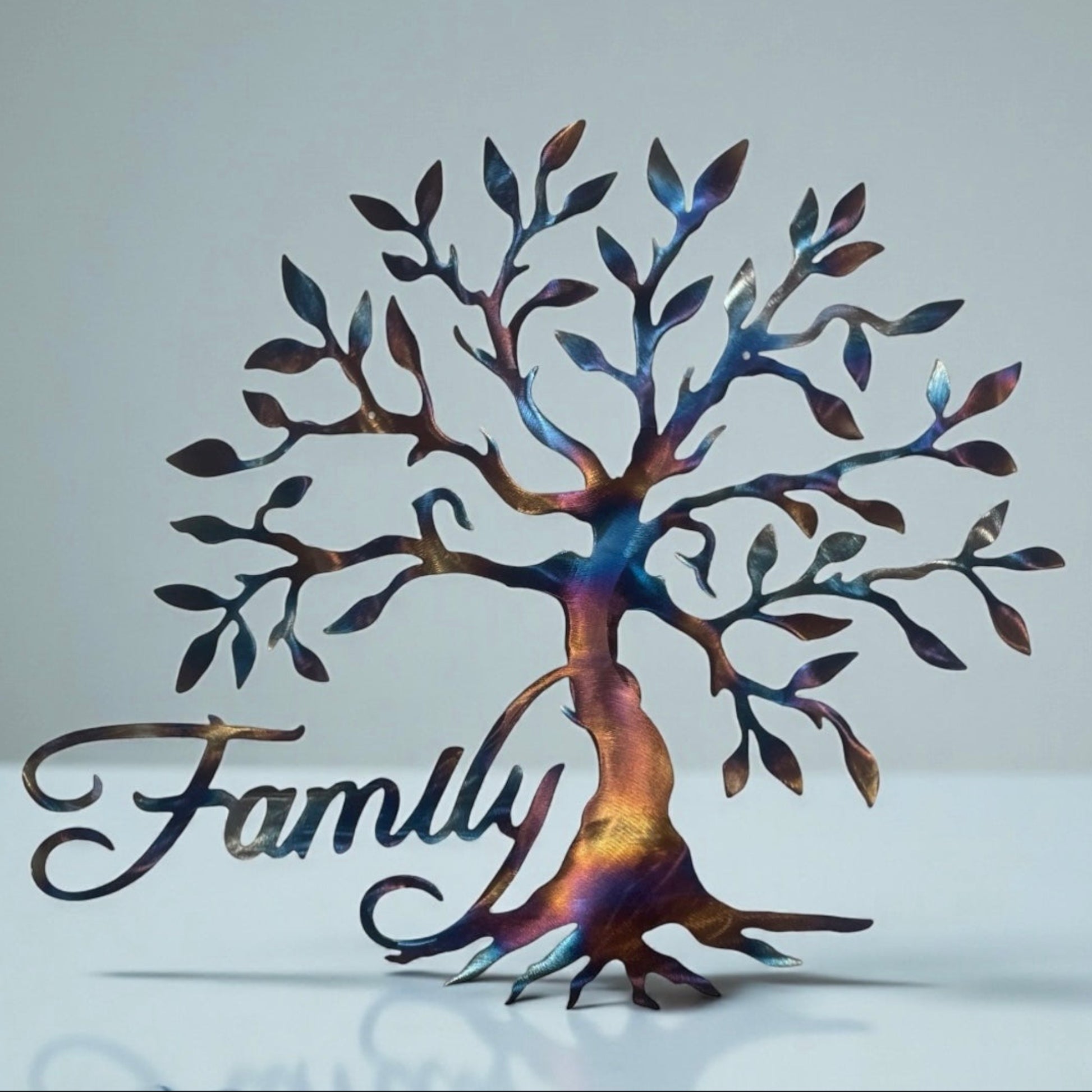Metal tree wall art with 'Family' text on a light gray background