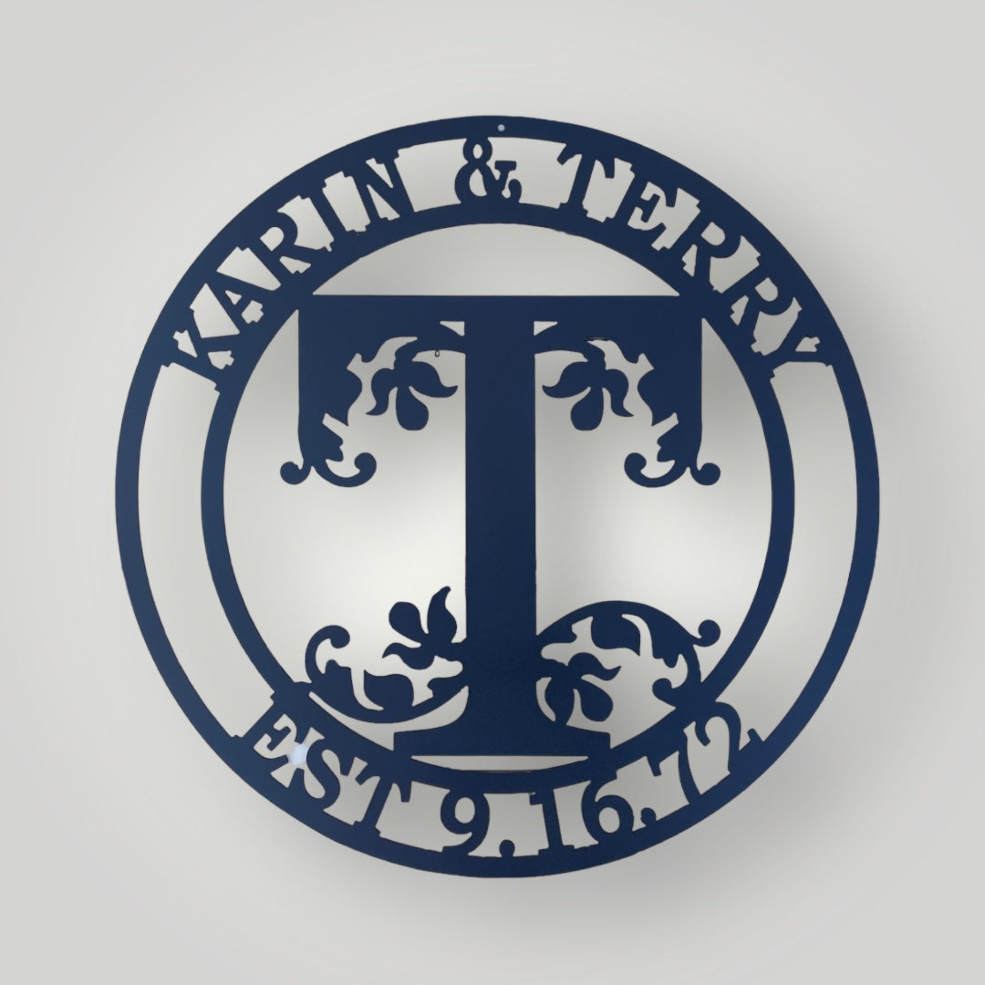 Monogram metal wall sign with two names and initial and date.
