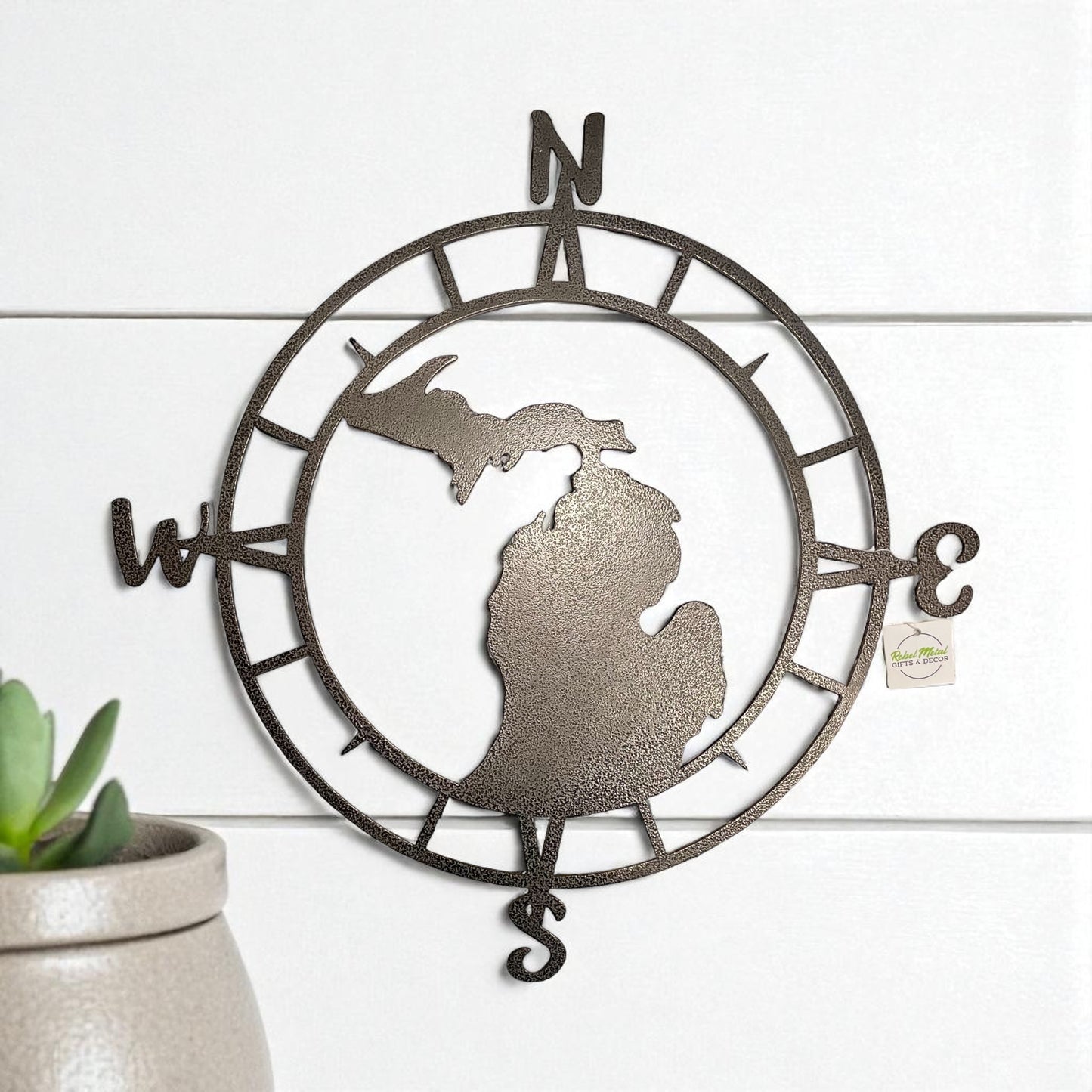 Decorative wall art with a compass design and Michigan shape on a white background