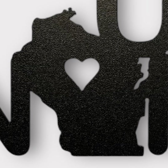 Black metal wall art with 'Up North' text on a white background