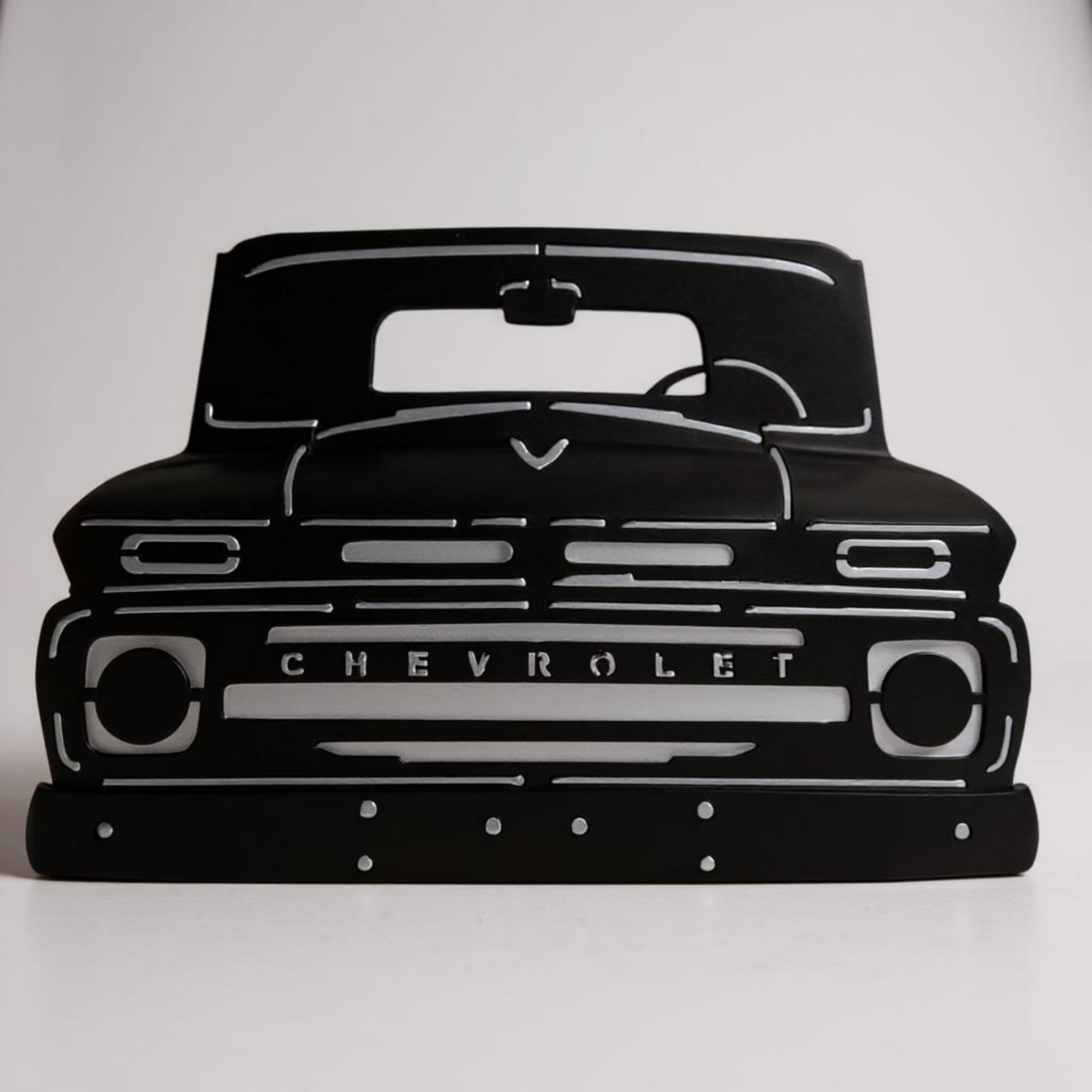 Black silhouette of a Chevrolet truck on a white background