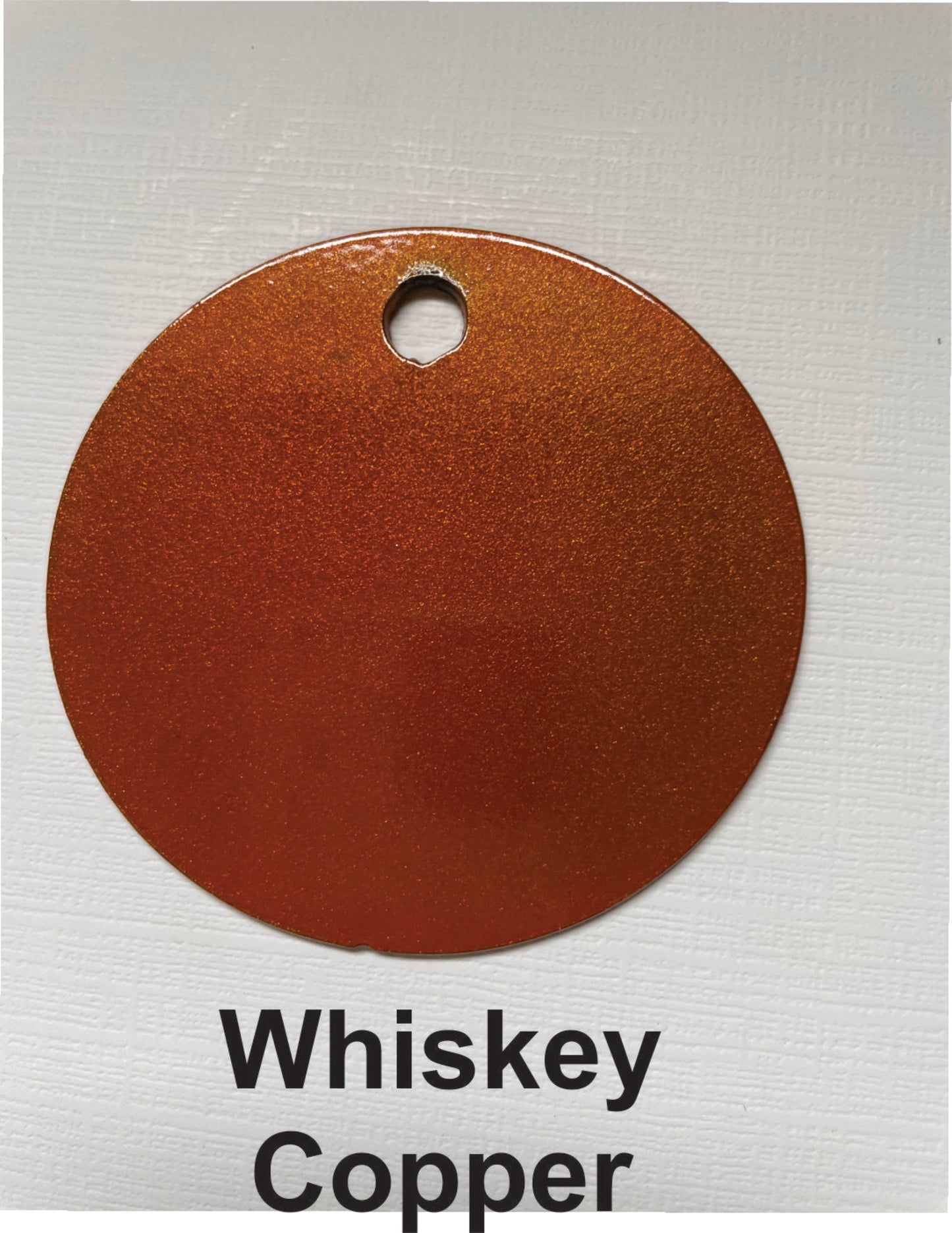 Round swatch of whiskey copper color on a white background