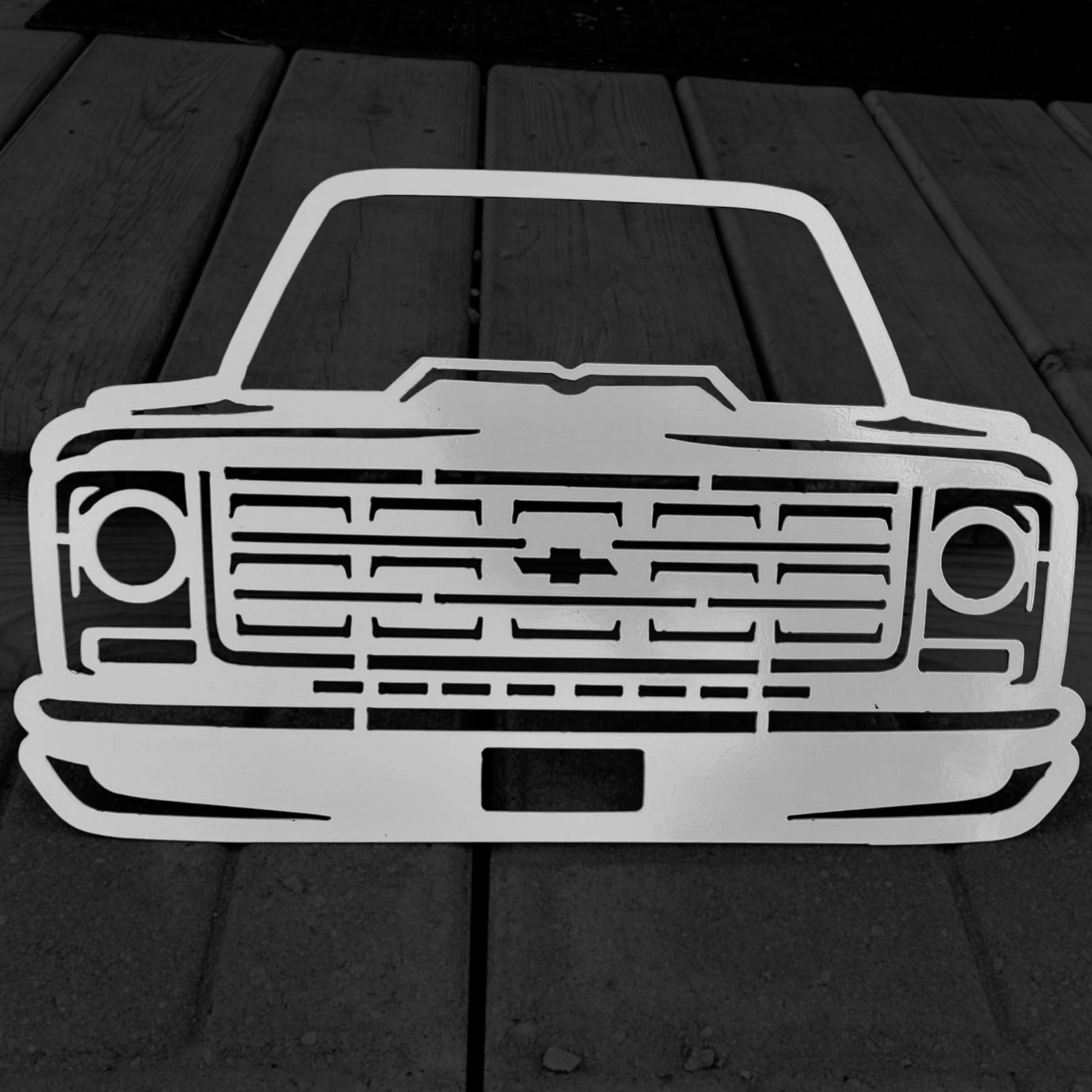 Metallic car front design on a wooden surface