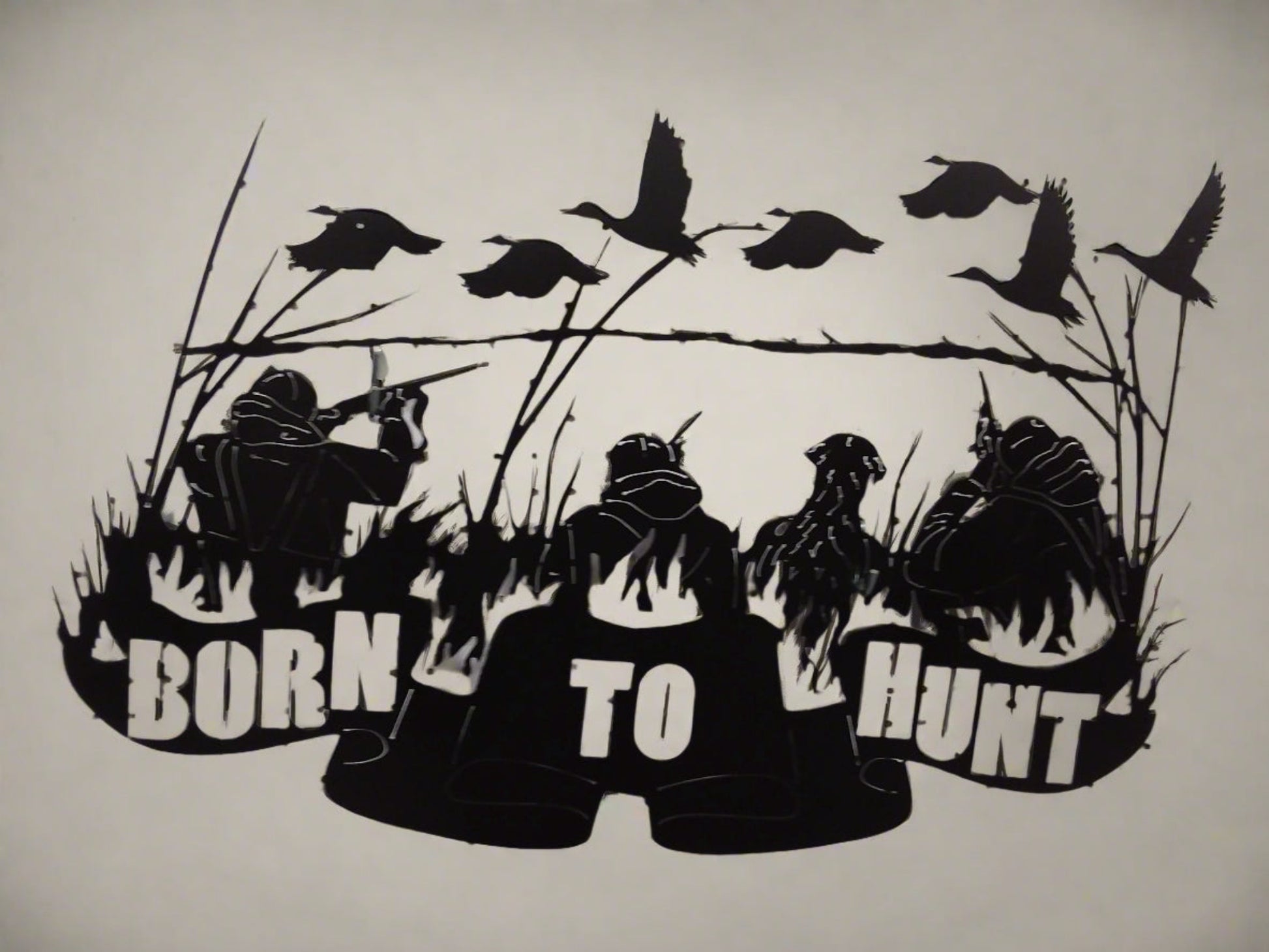 Metal art that says "Born to Hunt" with hunters a dog and geese.