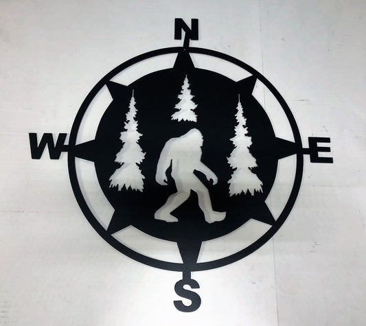 Bigfoot is walking amongst the trees in the metal directional compass