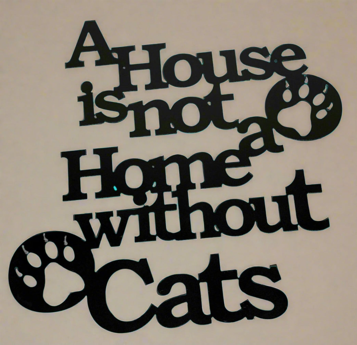 Metal wall sign that reads "A House is not a Home without Cats.  Two cat paw prints included