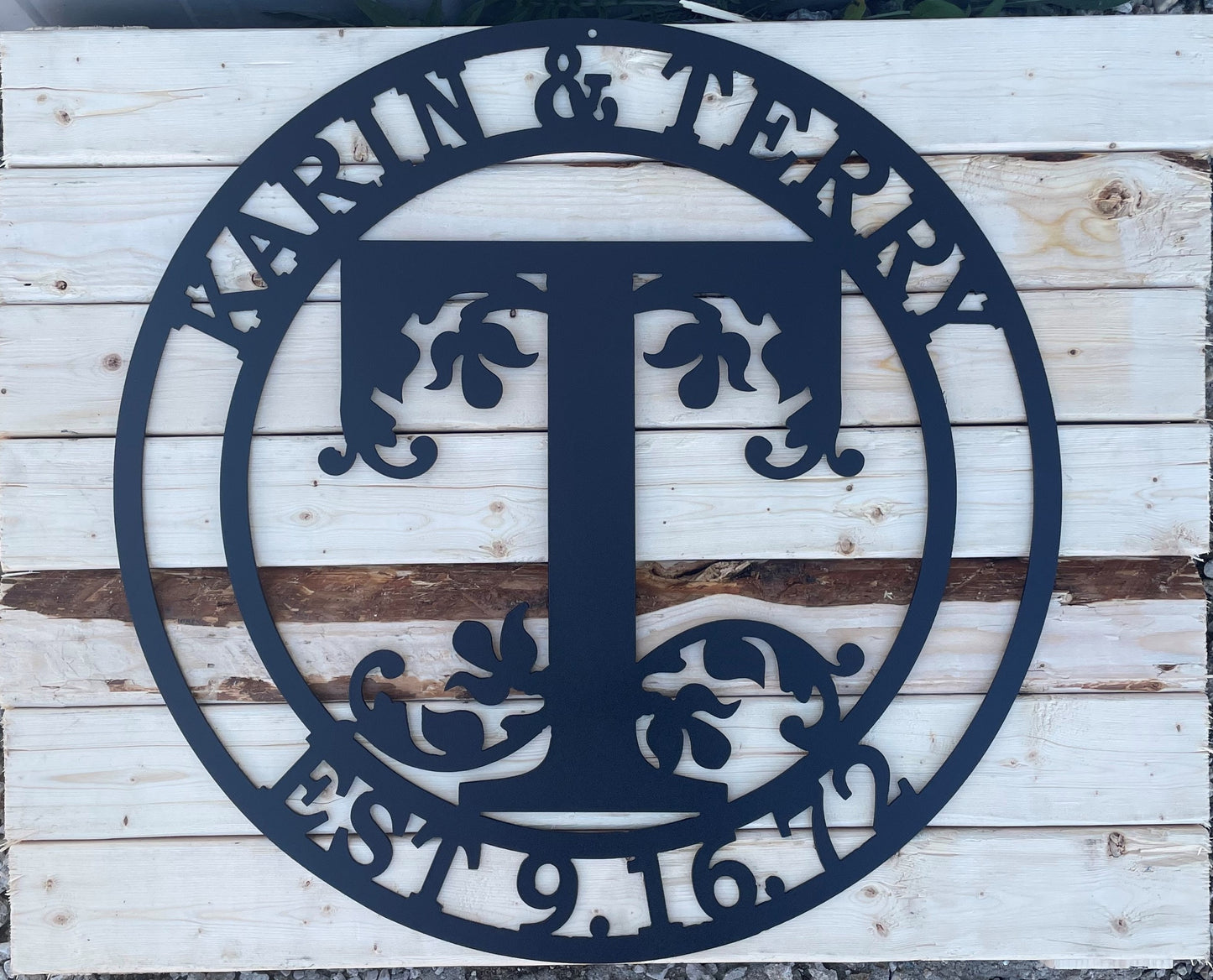 Monogram metal sign with two first names, an initial for last name and an Est. date.
