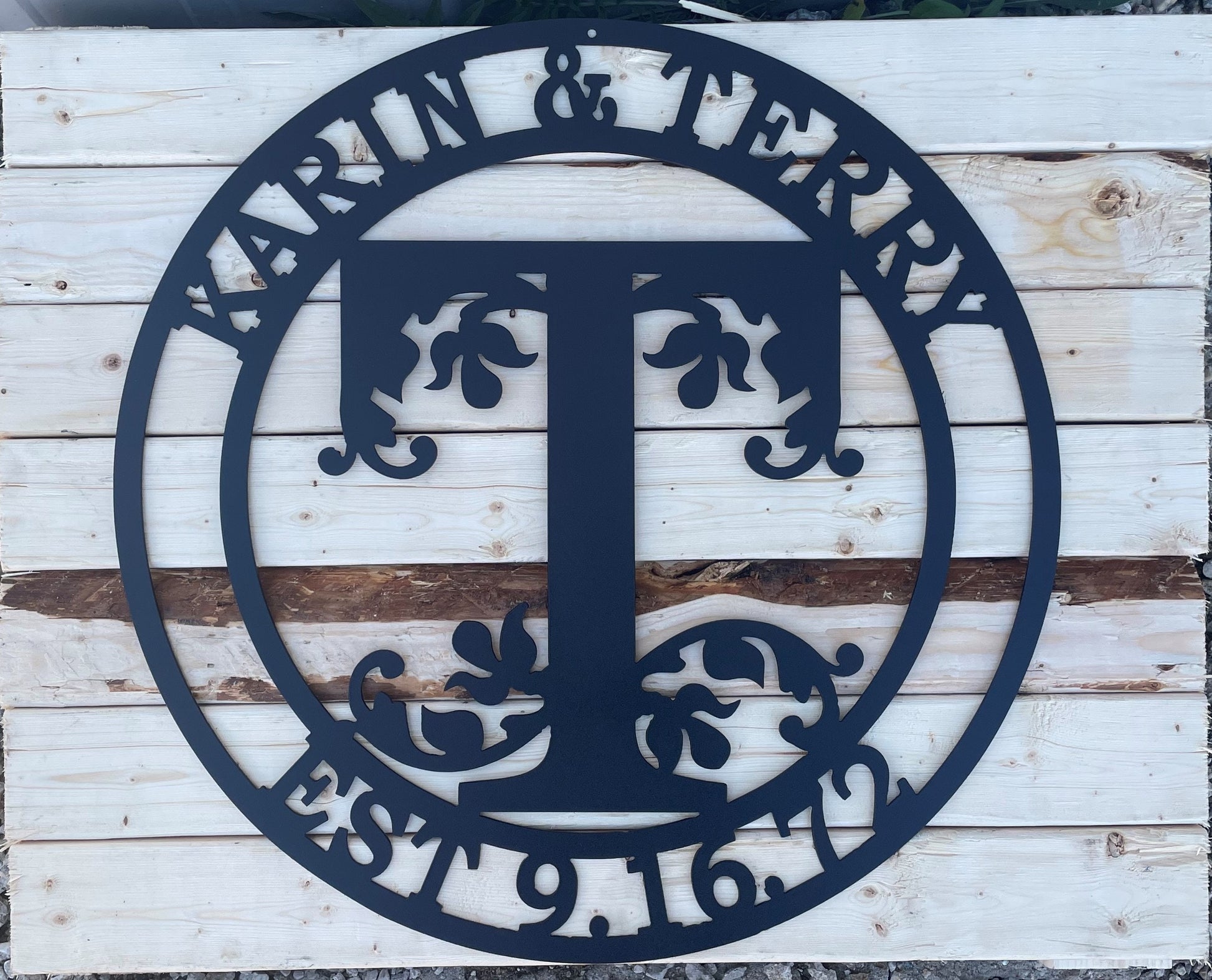 Monogram metal sign with two first names, an initial for last name and an Est. date.