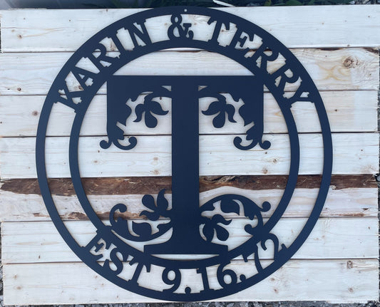 Monogram metal sign with two first names, an initial for last name and an Est. date.