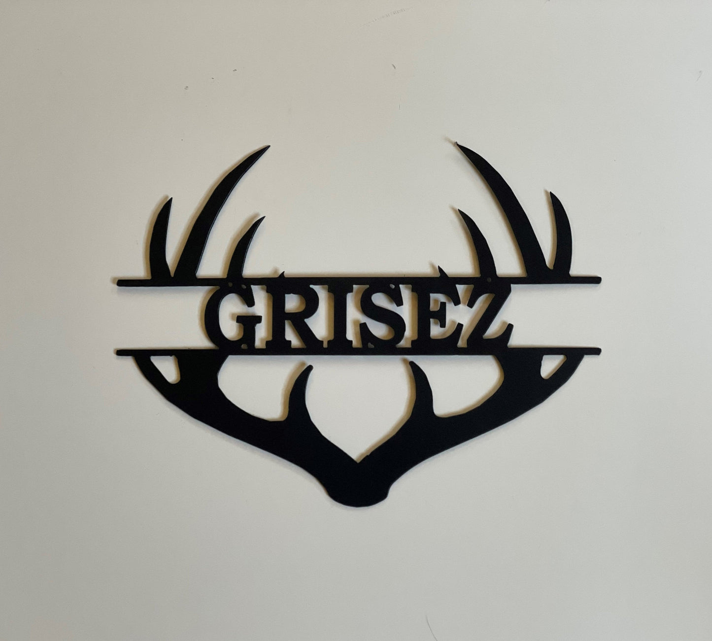 Custom antler metal sign with a name in the middle