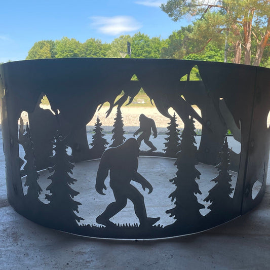 A black metal fire ring pit with a bolt-together 4 panel system featuring a silhouette design of a character in the woods.