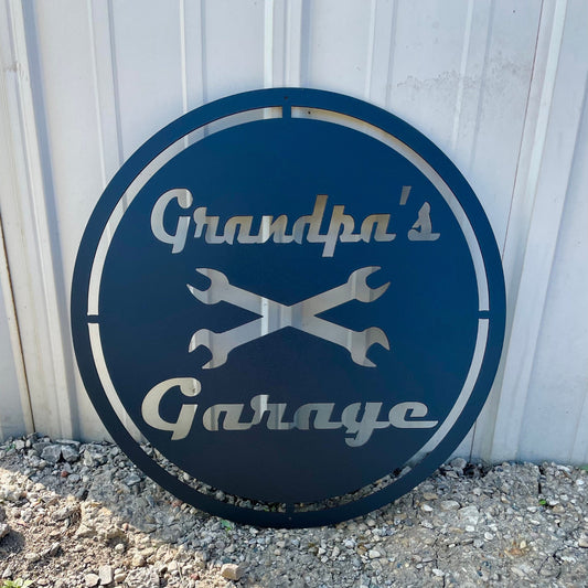 Round grandpa's garage metal sign with crossed wrenches.  Black with a retro feel.