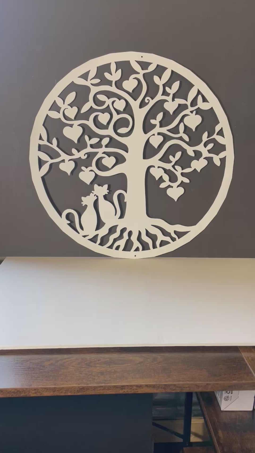 video of white metal art tree with heart shaped leaves and two loving cats